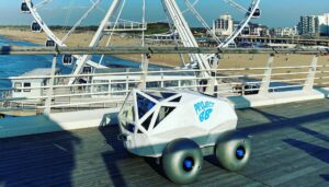 BeachBot sits on a raised boardwalk at Scheveningen Beach with the Ferris wheel in the background