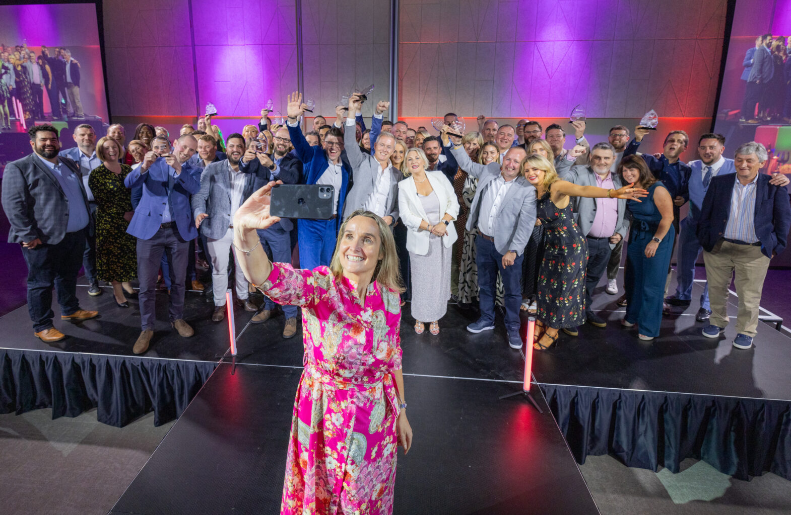 Group of people taking a selfie on stage