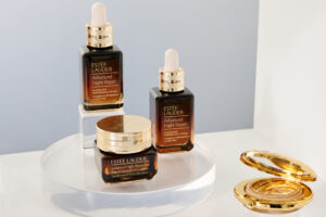 Products from Estee Lauder's Advanced Night Repair collection on a round glass tray.